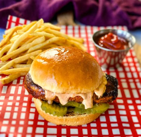 How does Blackened Chicken Sandwich with French Fries and a 20oz Fountain Beverage fit into your Daily Goals - calories, carbs, nutrition