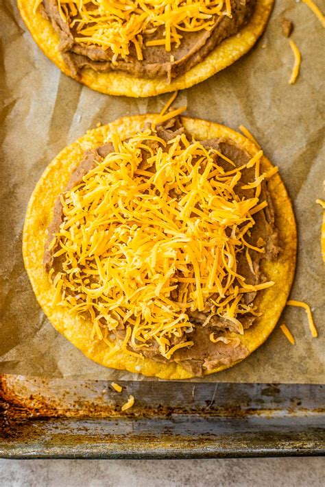 How does Fast foods, tostada, with beans, beef, and cheese fit into your Daily Goals - calories, carbs, nutrition