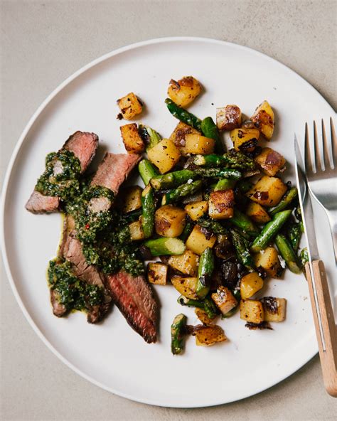 How does Grilled Flank Steak, Chimichurri, Roasted Potatoes, Lemon Asparagus fit into your Daily Goals - calories, carbs, nutrition