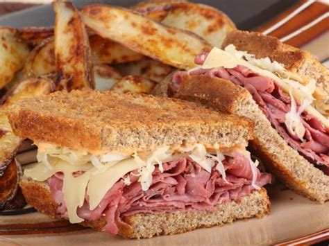 How does Grilled Reuben Sandwich with French Fries and a 20oz Fountain Beverage fit into your Daily Goals - calories, carbs, nutrition