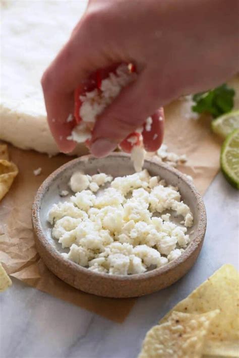 How does Queso Fresco Crumbled 1 oz fit into your Daily Goals - calories, carbs, nutrition