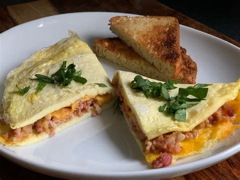 How does Sand Brkf English Muffin Omelet Bacon & Cheddar fit into your Daily Goals - calories, carbs, nutrition