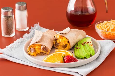 How does Sausage, Egg Cheese Wrap Platter with Hash Browns and Cantaloupe fit into your Daily Goals - calories, carbs, nutrition