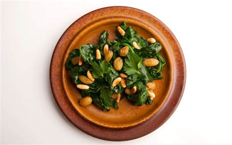 How does Sauteed Spinach with Pine Nuts and Golden Raisins fit into your Daily Goals - calories, carbs, nutrition