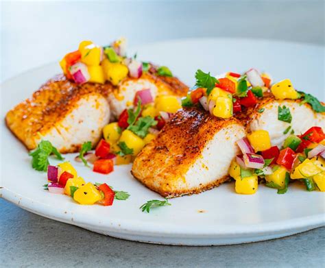 How does Sea Bass with Mango Salsa & Tomato Salad fit into your Daily Goals - calories, carbs, nutrition