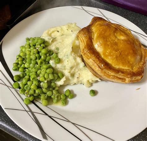 How does Steak and Guinness Pie Served with Mashed Potatoes & Garden Peas fit into your Daily Goals - calories, carbs, nutrition