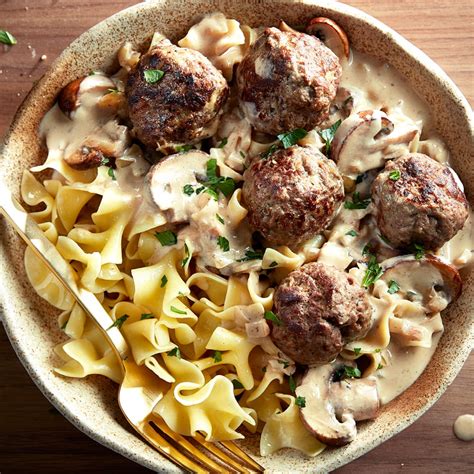 How does Swedish Meatballs over egg noodles with dinner roll and sour cream fit into your Daily Goals - calories, carbs, nutrition