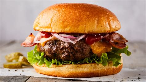 How does angus beef burger (80/20) (94936.4) fit into your Daily Goals - calories, carbs, nutrition