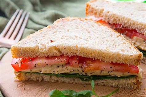 How many carbs are in hummus club sandwich with a tomato, onion and cucumber salad - calories, carbs, nutrition